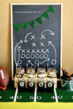 a football themed party with drinks and snacks on the sidelines, along with a chalk board