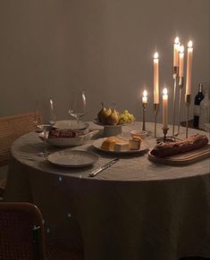 a dinner table with candles and food on it