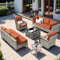 an outdoor living area with wicker furniture