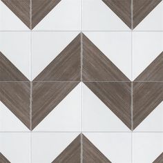 a white and brown tiled wall with an arrow pattern on the bottom right hand corner