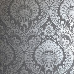 a gray and white wallpaper with an intricate design on it's side,