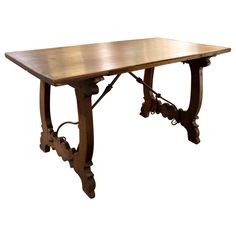 an old wooden table with ornate carvings on the legs and base, against a white background