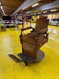 a chair that is sitting in the middle of a parking garage with yellow paint on the floor