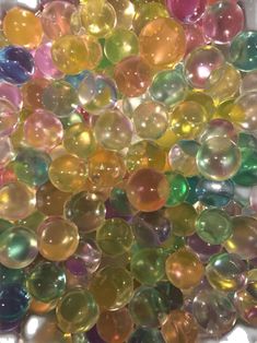 many different colored bubbles in a white container