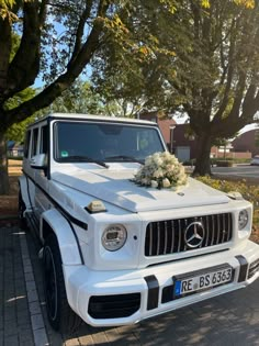 a wedding car parked on the side of the road