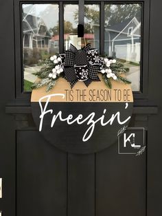 a black door with a sign that says it's the season to be freegin