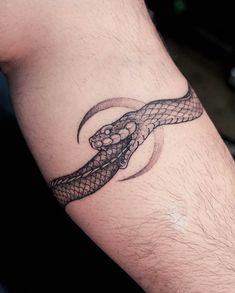 a man's arm with a snake tattoo on it