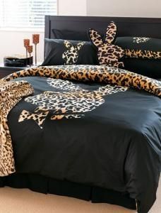 a leopard print comforter set on a bed