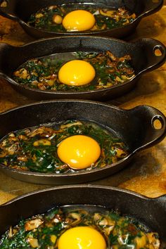 three skillets filled with eggs on top of a counter