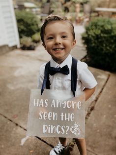 a young boy holding a sign that says has anyone seen the princess?