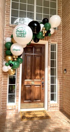 the front door is decorated with balloons and streamers for st patrick's day