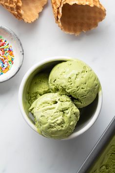 three scoops of green ice cream in a bowl