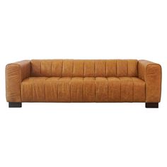 a brown leather couch sitting on top of a white floor