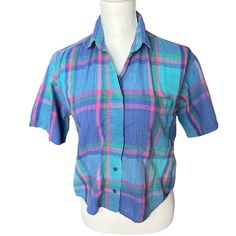 Vtg 80s Plaid Short Sleeve Buttondown Shirt Blue Pink High Low Cotton Small. Made By Details In India. This Blouse Has Some Hidden Buttons On The Front, Is Shorter In The Front And Longer In The Back. Super Soft Lived In Cotton Makes It Perfect For Summer Days Preppy Travel Vacation Coastal Outfits. P2p Measures About 19” Across Laying Flat, Length Is 20” In The Front And 24” In The Back. There Is A Small Pull On The Front. Items That Are Preused/Preworn Are Not In Perfect Condition. Please Look 90s Inspired Short Sleeve Shirt For Spring, Vintage Blue Button-up Shirt, 90s Blue Collared Shirt, 90s Style Blue Collared Shirt, 90s Blue Button-up Top, 90s Style Blue Spring Shirt, Blue 90s Style Shirt For Spring, 90s Style Blue Shirt For Spring, Preppy 80s