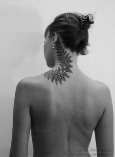 a woman with a tattoo on her back