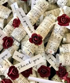 many pieces of music paper with red roses on them