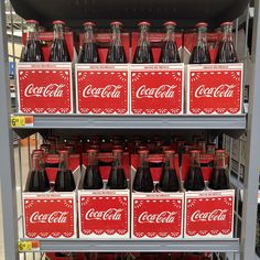 coca - cola bottles are stacked on shelves in a store