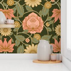 a vase sitting on top of a counter next to a wallpaper covered in flowers