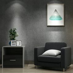 a living room with a chair, lamp and pictures on the wall in it's corner