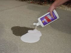 a person is pouring cement onto the ground