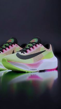 the nike air zoom flyknit 2 is shown in neon green and pink