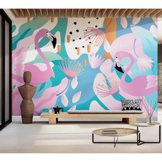 a living room with flamingos painted on the wall and coffee table in front of it