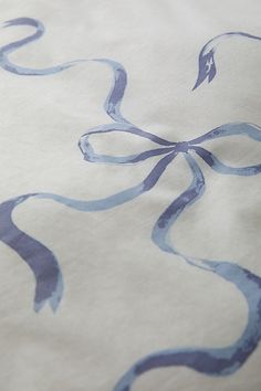 a close up of a blue and white fabric with an abstract design on it's surface