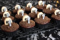 chocolate cupcakes decorated with white frosting and spooky decorations