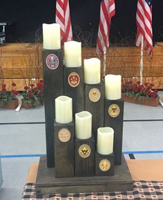 several candles are placed on top of each other in front of an american flag display