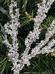 an ornament is hanging from a christmas tree with snowflakes on it