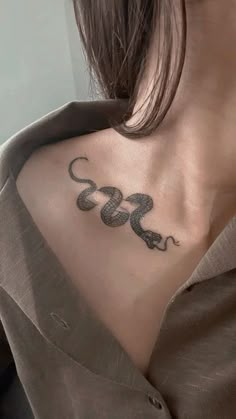 a woman with a snake tattoo on her chest