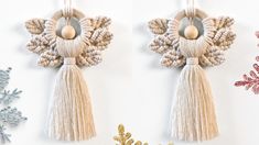 two tasseled ornaments hanging from hooks next to snowflakes