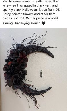 a fake moon made out of black flowers on a white wall with the caption'my halloween moon wreath i used the spooky black flower ribbon from dr