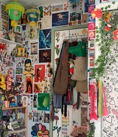 a room filled with lots of pictures and magnets on the wall next to a door