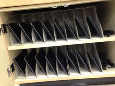 a book shelf filled with lots of black folders