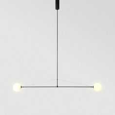 three lights are hanging from the ceiling in a room with white walls and flooring