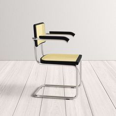 a black and yellow chair sitting on top of a wooden floor next to a white wall