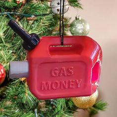 a red gas pump ornament hanging from a christmas tree