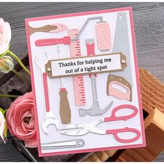 a card with pink flowers and scissors on it