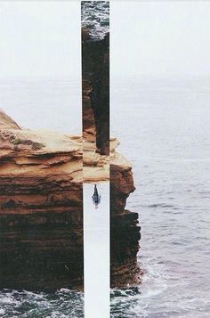 a person standing on top of a cliff next to the ocean