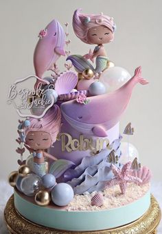 there is a cake that has mermaids on it