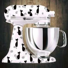 a white mixer with black cats on it