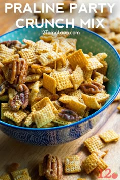 a bowl filled with cheetos and nuts on top of a wooden table