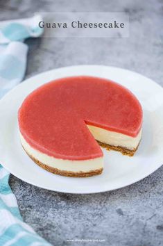 a cheesecake on a white plate with a piece cut out