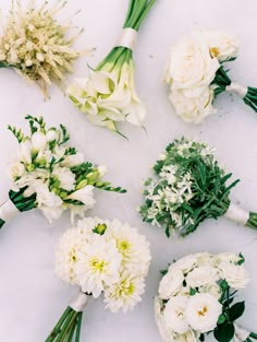 flowers laid out on a white surface to be used as bouquets for bridesmaids