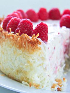 a piece of cake with raspberries on top