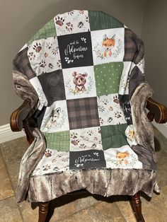 a chair with a patchwork blanket on top of it and a name written on the back