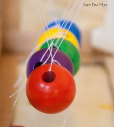 an image of colorful toys hanging from strings