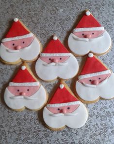 decorated cookies with santa clause on them are arranged in the shape of santa's head