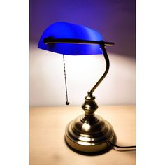 a blue lamp sitting on top of a wooden table